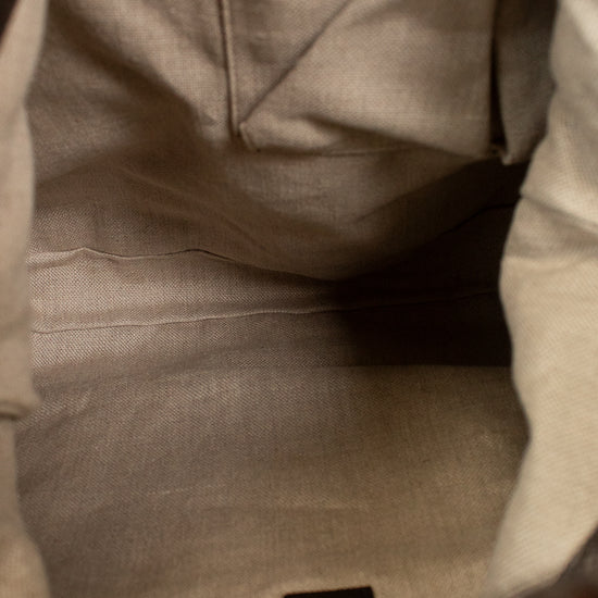 Close-up of a gray fabric pocket with a label on a garment.