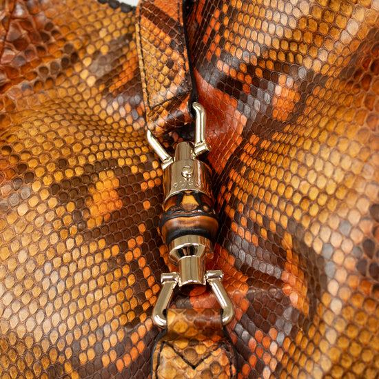 Close-up of a brown leather bag with a silver clasp