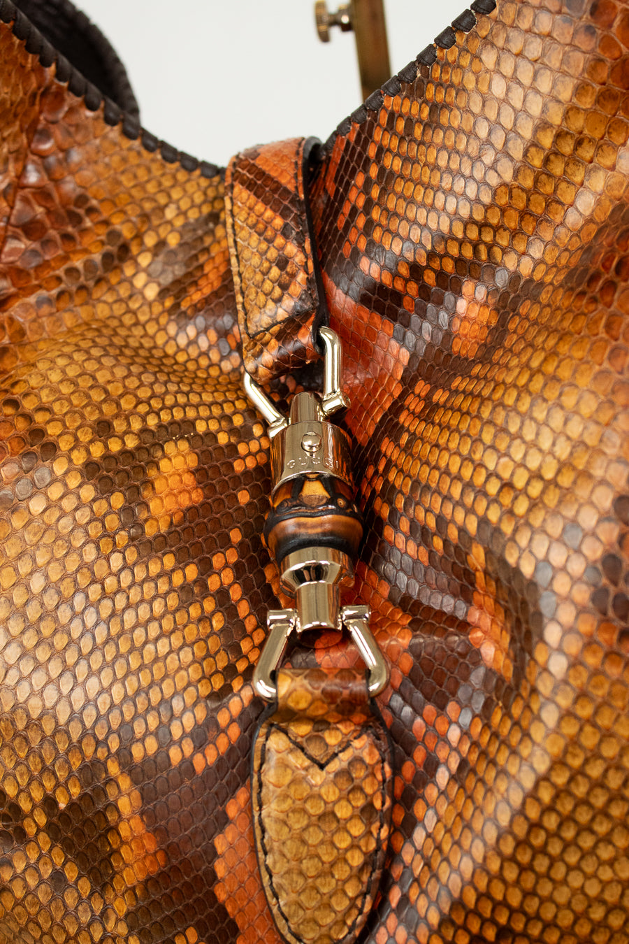 Close-up of a brown leather bag with a silver clasp
