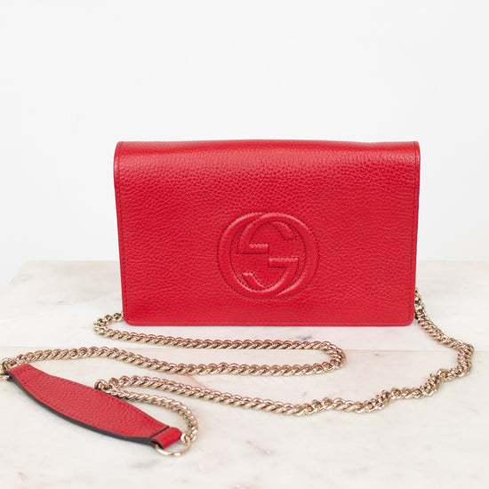 Red handbag with gold chain on a white background