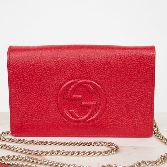 Red handbag with gold chain on a white background