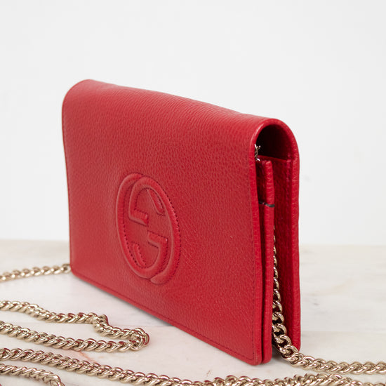 Red handbag with gold chain on a white background