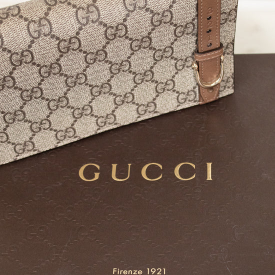 Gucci handbag with brown strap on a Gucci branded box