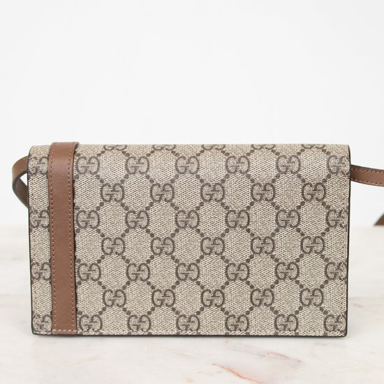 Designer handbag with brown and beige pattern on a white background