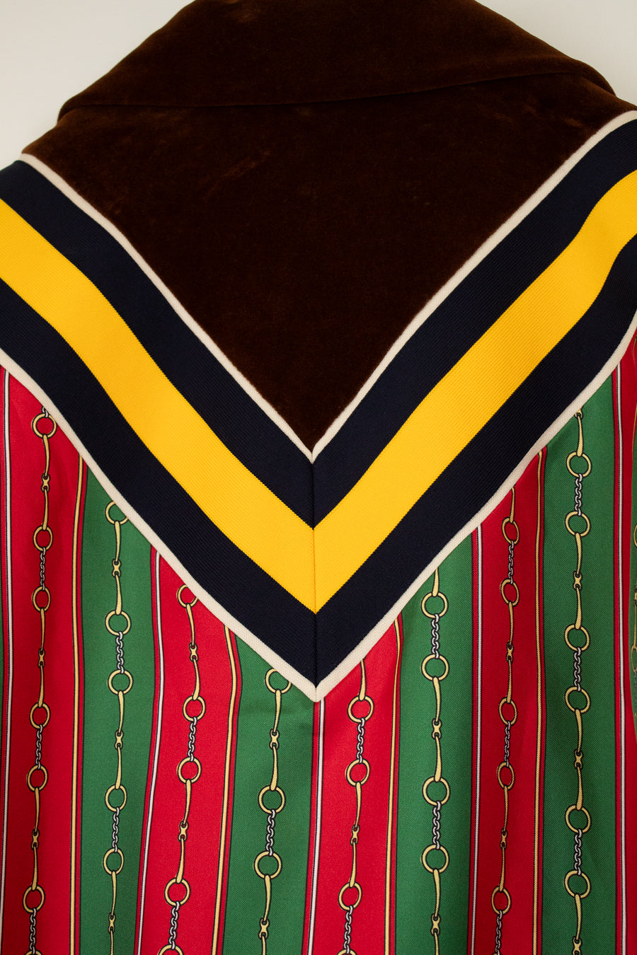 Jacket with brown top, yellow and black stripes, and red and green stripes with chain details.