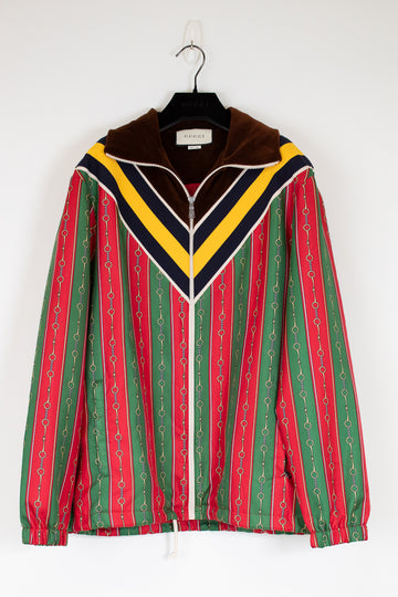 Colorful striped jacket on a hanger against a white background