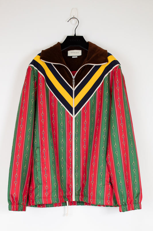 Colorful striped jacket on a hanger against a white background