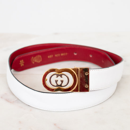 White and red reversible belt  on a marble surface