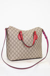 Beige handbag with red accents on a white background