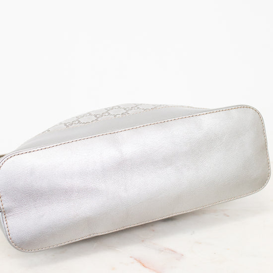 Silver bottom of bag on a marble surface