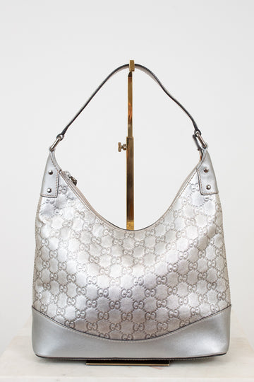 Silver Gucci handbag on a white background