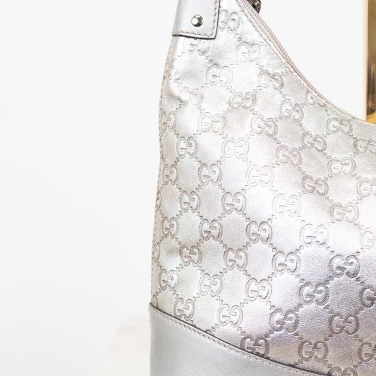 Silver Gucci handbag with logo pattern on a white background
