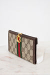 Gucci wallet with monogram pattern on a white background