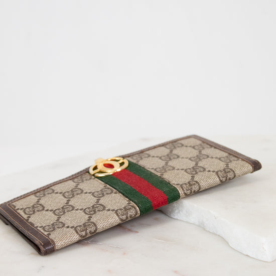 Designer wallet with brand logo on a marble surface