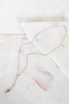 Silver necklace on marble surface 