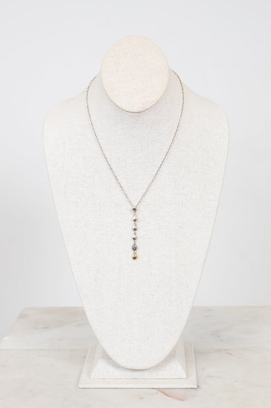 Necklace displayed on a mannequin bust against a white background
