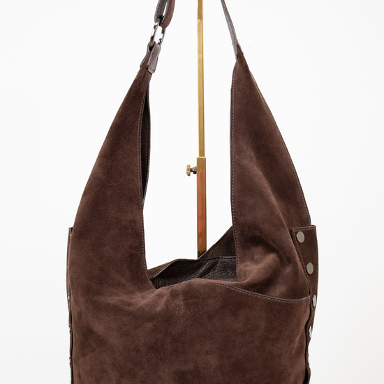 Brown suede handbag with a strap on a white background