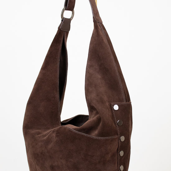 Brown suede handbag with a strap on a white background
