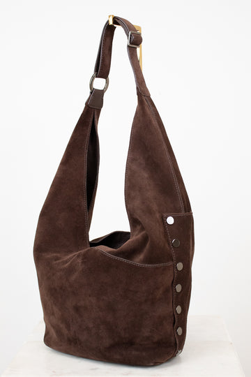 Brown suede handbag with a strap on a white background