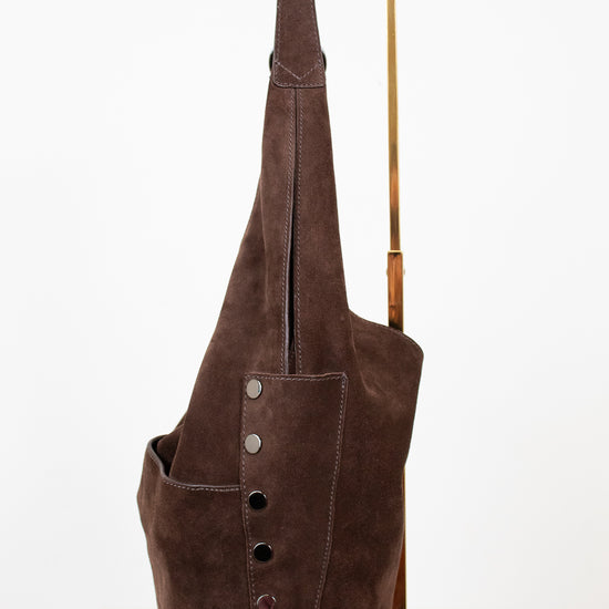 Brown leather hobo bag with buttons on a white background