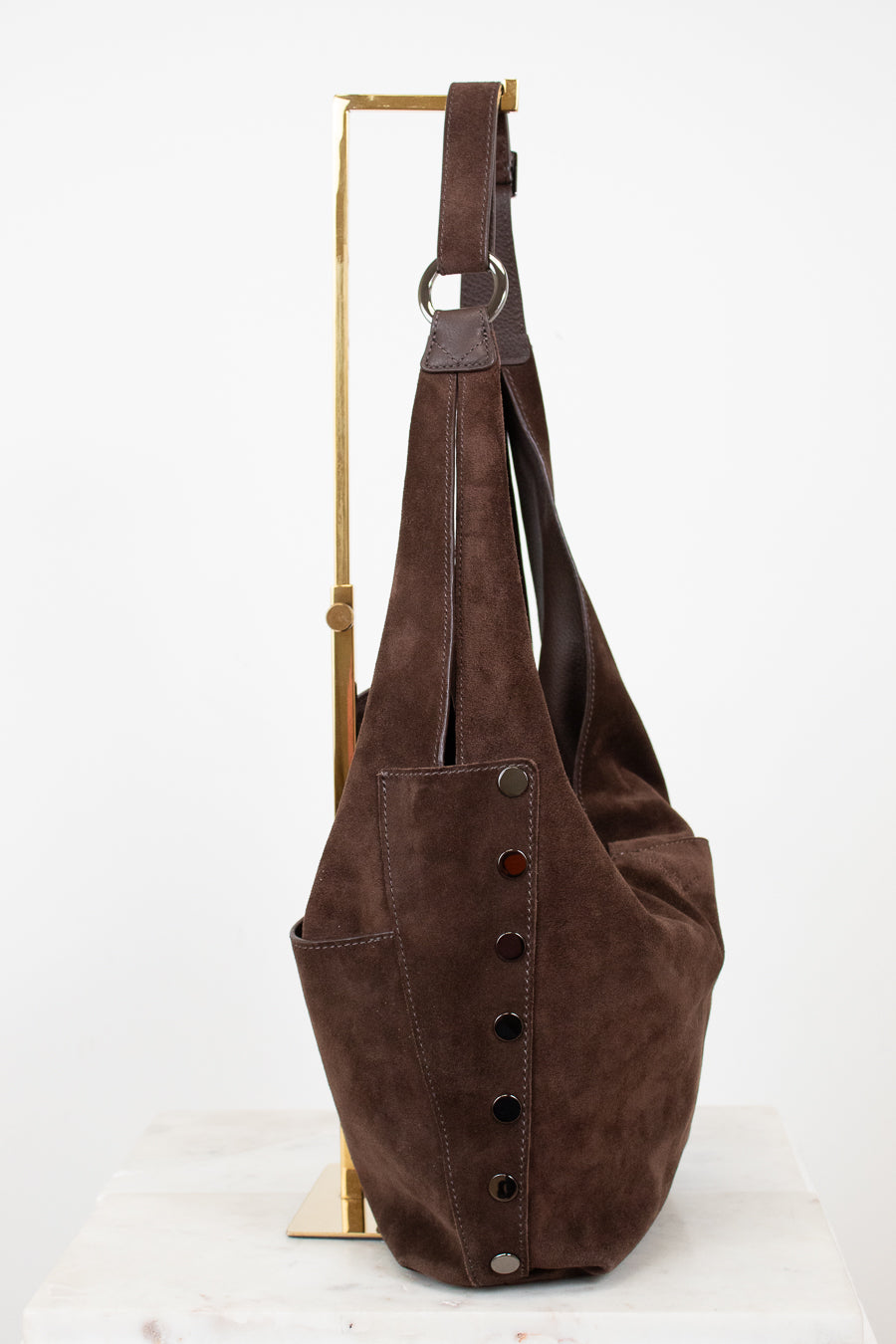 Brown leather bag with buttons on a white background