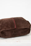 Brown suede to hobo bag with red stitching on a white background