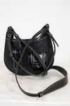Black leather handbag with a strap on a white background