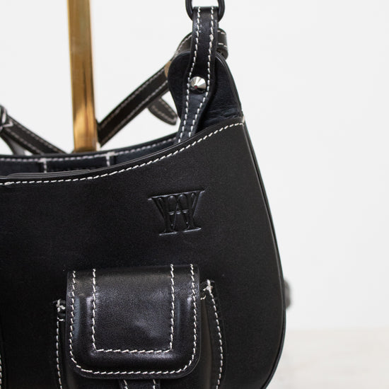 Black leather handbag with a visible brand logo on a white background