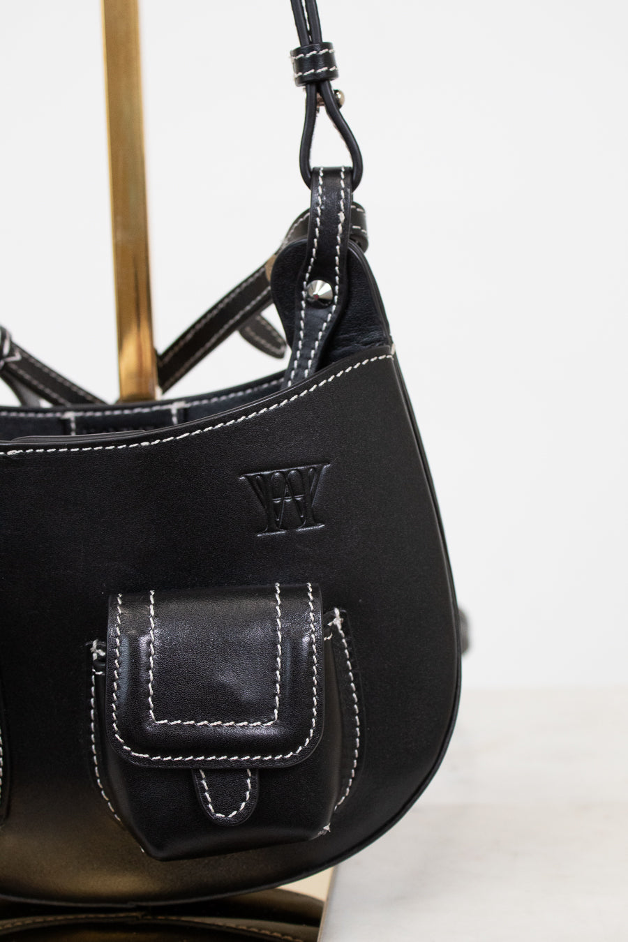 Black leather handbag with a visible brand logo on a white background