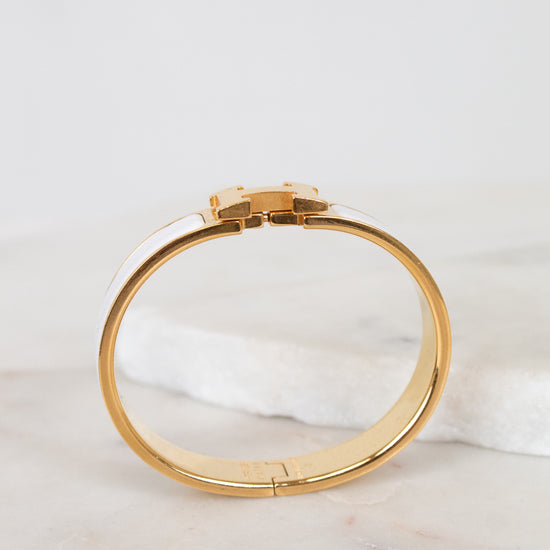 Gold bracelet on a marble surface