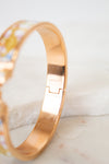 Rose gold bracelet on a white marble surface