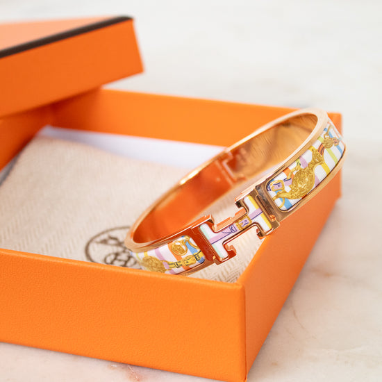 Rose gold bracelet with colorful design on an orange box