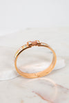Rose gold bracelet with gemstones on a marble surface