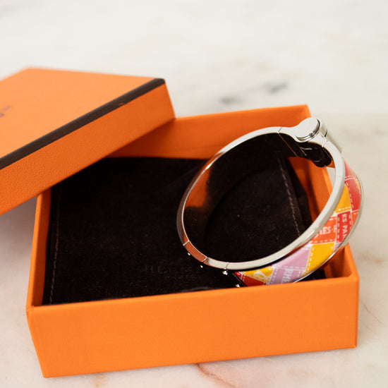 Bangle in an open orange box on a marble surface