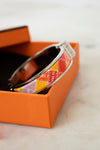 Color bracelet in an orange box on a marble surface
