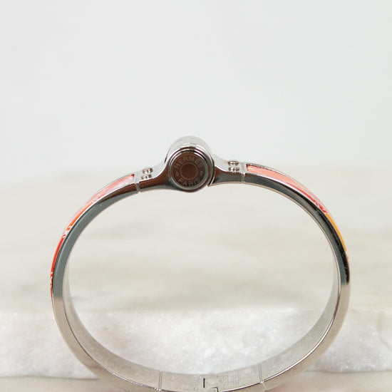 Silver bracelet with hinge on a marble surface