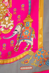 Colorful scarf with elephant design and Hermès Paris logo on a pink and gray background