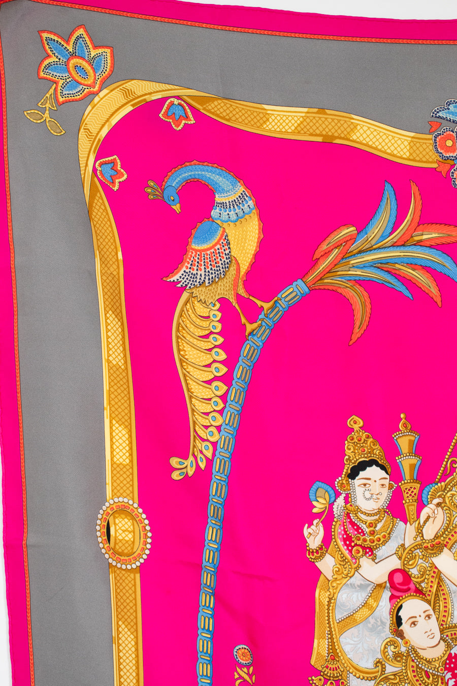 Decorative fabric with peacock design on a pink and gray background