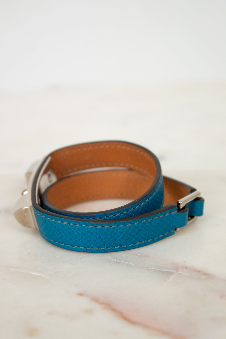 Blue leather bracelet on a marble surface