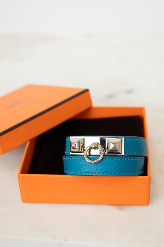 Blue leather bracelet with silver clasp in an orange box on a light background