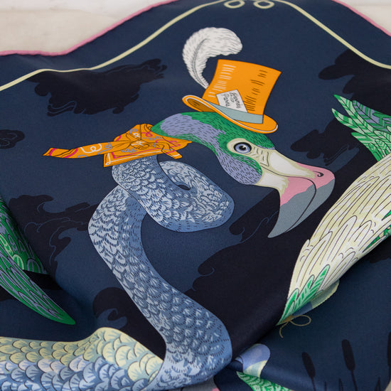 Colorful fabric with a pelican design wearing a top hat on a white background