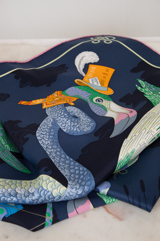 Colorful fabric with a pelican design wearing a top hat on a white background