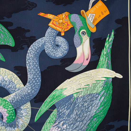 Decorative fabric with a stylized peacock and snake design on a dark background