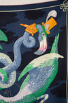Decorative fabric with a stylized peacock and snake design on a dark background