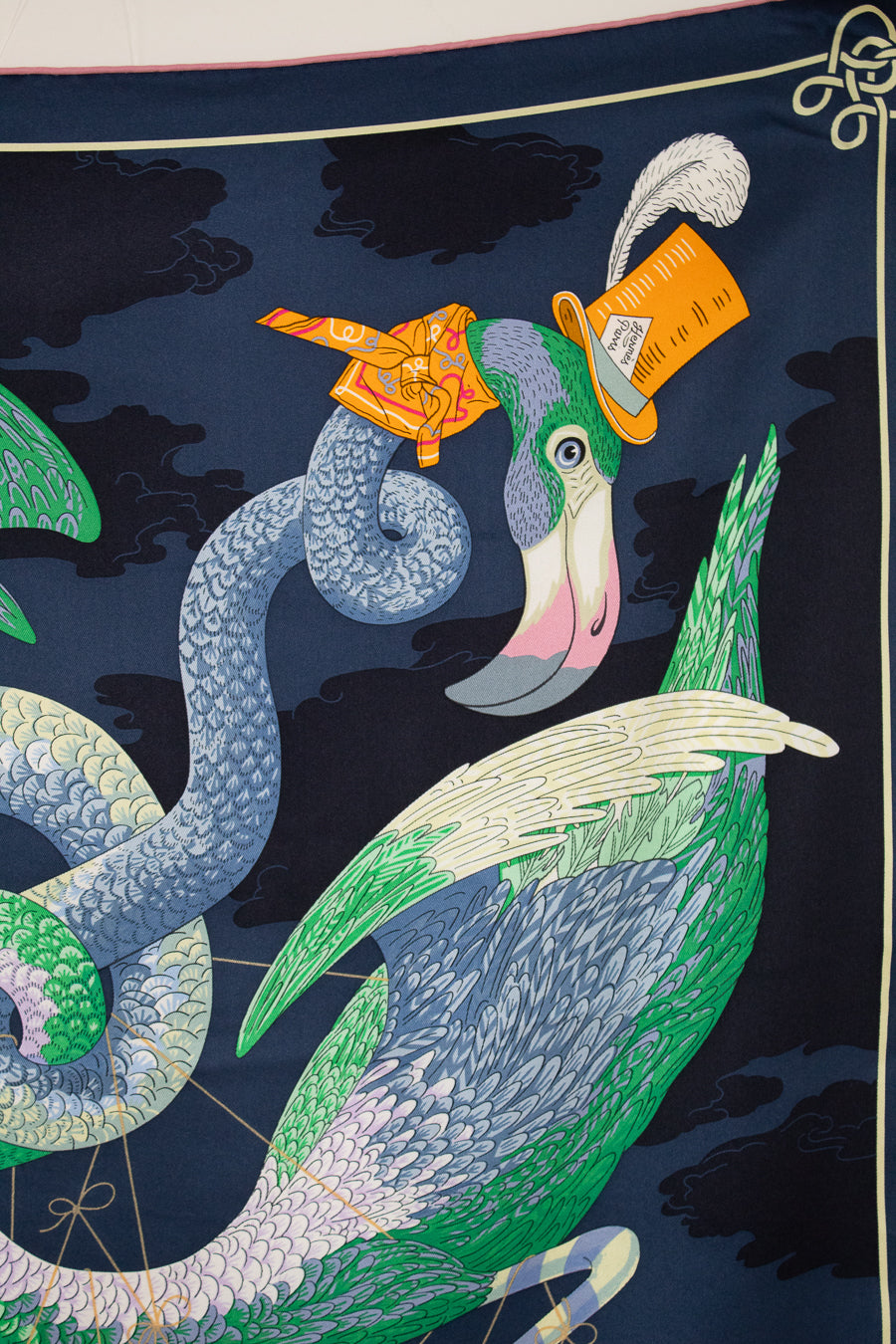 Decorative fabric with a stylized peacock and snake design on a dark background