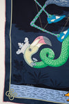 Silk scarf with a colorful bird design on a dark blue background