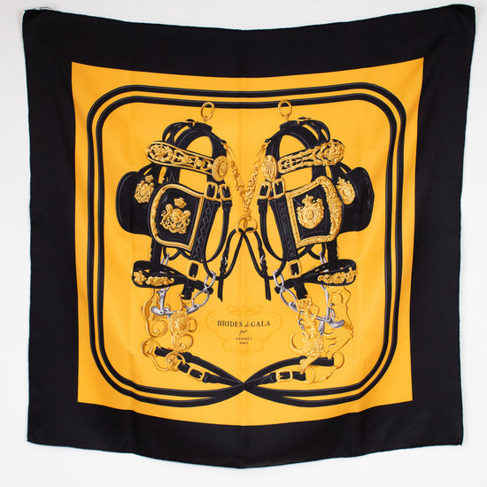 Black and yellow scarf with intricate design on a white background