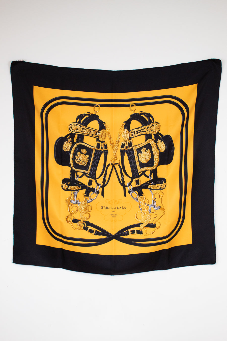 Black and yellow scarf with intricate design on a white background