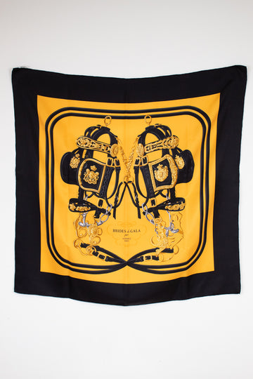 Black and yellow scarf with intricate design on a white background