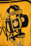Decorative black and gold horse bridle on a yellow scarf